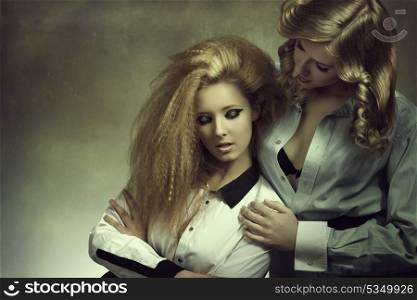 portrait of couple blonde girls with fashion style, creative make-up and hair-style and open shirt in sensual pose color in fashion