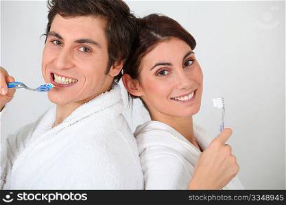 Portrait of couple brushing their teeth