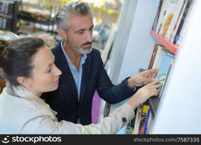 portrait of couple choosing books