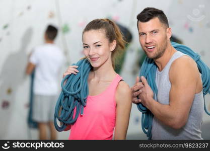 portrait of couple holding climbing ropes
