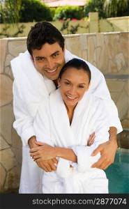 Portrait of couple in bathrobes, outdoors