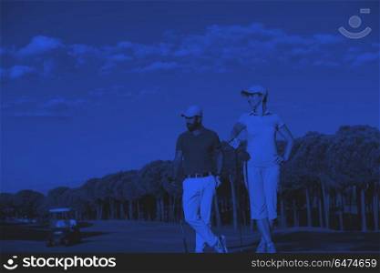 portrait of couple on golf course. portrait of happy young couple on golf course duo tone