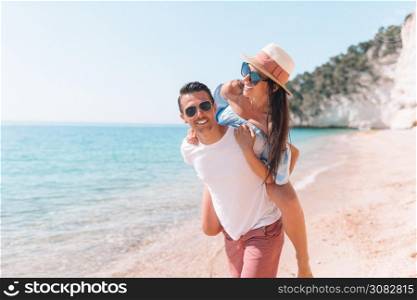 Portrait of couple on white beach. Happy family enjoy their honeymoon on the seashore. picture of happy couple in sunglasses on the beach