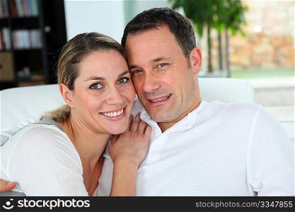 Portrait of couple relaxing at home in sofa