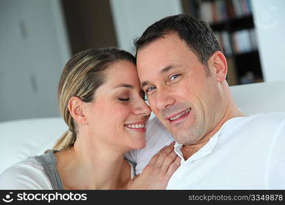 Portrait of couple relaxing at home in sofa