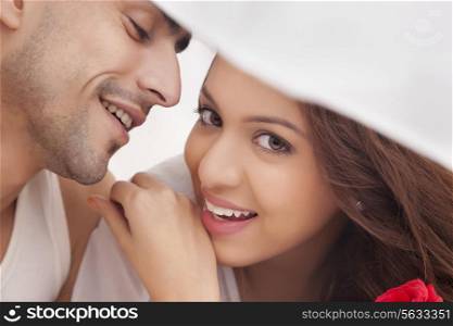 Portrait of couple romancing in bed