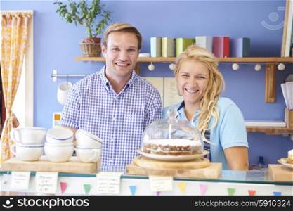 Portrait Of Couple Running Cafe Together