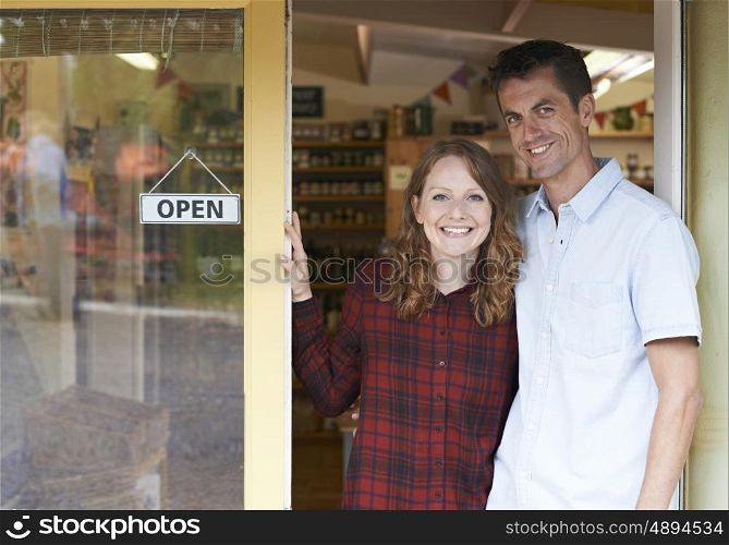 Portrait Of Couple Running Delicatessen Outside Store