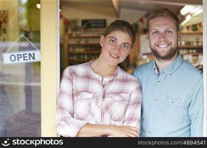 Portrait Of Couple Running Delicatessen Outside Store