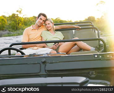 Portrait of couple sitting in jeep