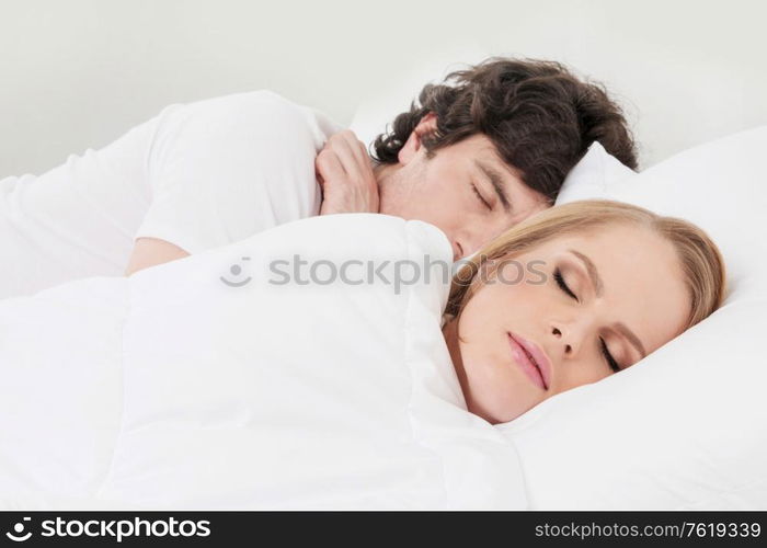 Portrait of couple sleeping in the bed close up focus on woman. Couple sleeping in the bed