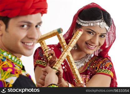 Portrait of couple with sticks dancing