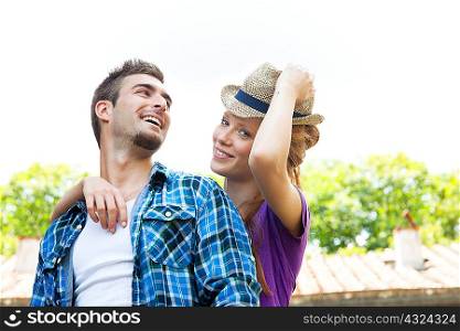 Portrait of couple, woman wearing straw hat