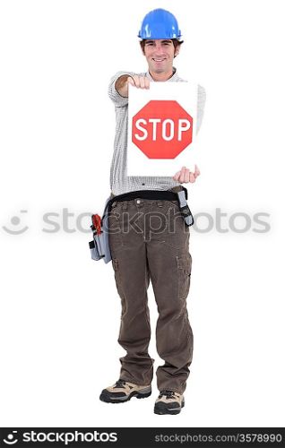 portrait of craftsman holding stop sign