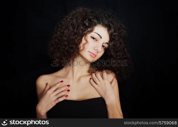 Portrait of curly girl with red manicure closeup