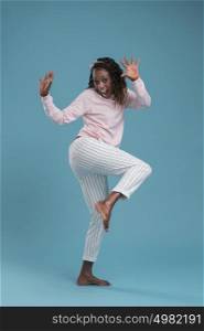 Portrait of cute african woman posing - dancing full length
