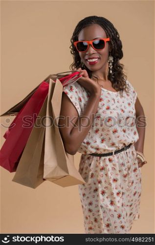 Portrait of cute african woman posing - shopping with bags