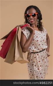 Portrait of cute african woman posing - shopping with bags