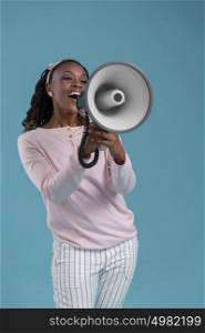 Portrait of cute african woman posing - speaking at megaphone