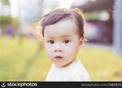 Portrait of cute and lovely curly hair asian chinese baby girl .