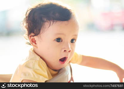 Portrait of cute and lovely curly hair asian chinese baby girl .