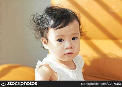 Portrait of cute and lovely curly hair asian chinese baby girl .