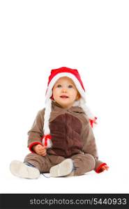 Portrait of cute baby in Santa hat looking up&#xA;