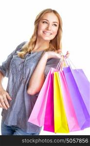 Portrait of cute blond girl holding in hands paper bags isolated on white background, enjoying shopping, happy consumer concept