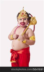 Portrait of cute boy dressed as Lord Hanuman against white background