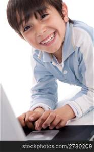 Portrait of cute caucasian boy smiling with laptop over white background
