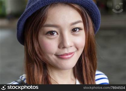 Portrait of cute Chinese girl in a knitted cap