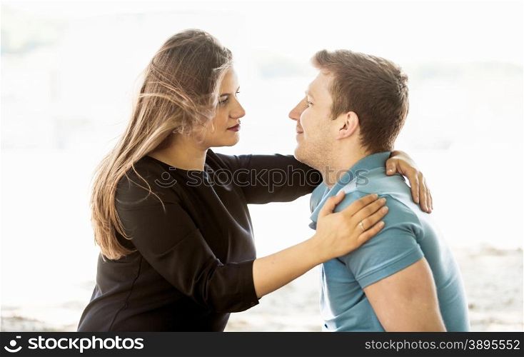 Portrait of cute couple in love looking at each other at park