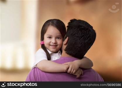 Portrait of cute girl hugging her father