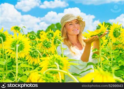Portrait of cute girl in sunflowers field, holding in hands one big yellow flower, bright sunny day, summer holidays, enjoying countryside nature