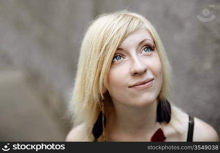 portrait of cute girl on grey urban background, selective focus