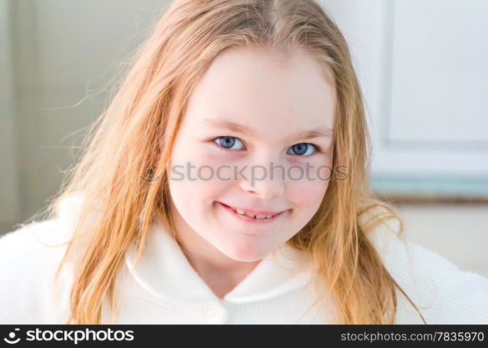 Portrait of cute girl with blond hair in white