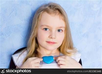 Portrait of cute girl with blue heart