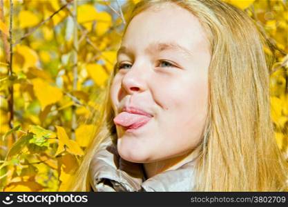Portrait of cute girl with put out tongue
