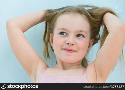 Portrait of cute girl with upwards hands and blond hair
