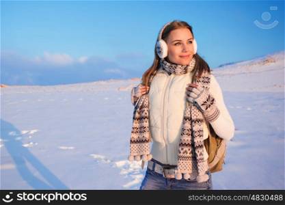 Portrait of cute happy female spending winter holidays in the mountains, enjoying beautiful snowy view, healthy active lifestyle
