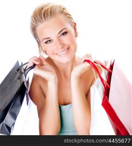 Portrait of cute happy girl with shopping bags isolated on white background, enjoying seasons sales, spending money with pleasure