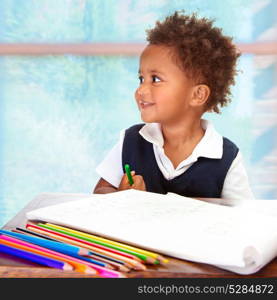 Portrait of cute little African preschooler on drawing lesson, painting with many colorful pencils, elementary education concept