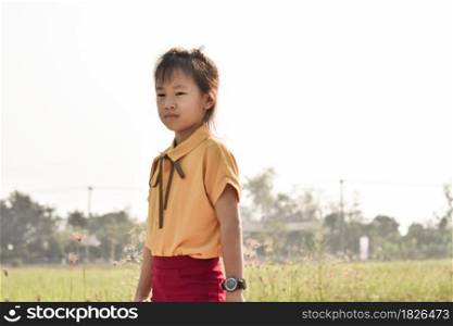Portrait of cute little girl outdoors in summer day.