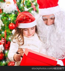 Portrait of cute little girl receive gift box from Santa Claus, celebrating Christmas at home near beautiful decorated evergreen tree&#xA;