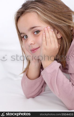 Portrait of cute little girl with hands on chin