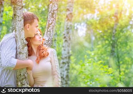 Portrait of cute loving couple in the park enjoying warm sunny day, spending time in birch grove, romantic date, love and happiness concept