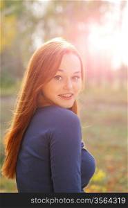 portrait of cute red haired young woman, outdoor, backlit