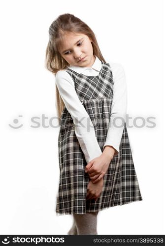 Portrait of cute shy schoolgirl against isolated background