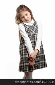 Portrait of cute shy schoolgirl against isolated background