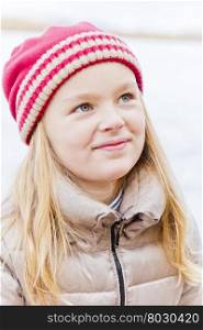 Portrait of cute smiling girl in red hat